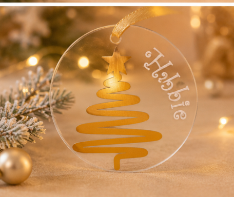 A clear Christmas ornament featuring a golden tree design and the name "Habbie."